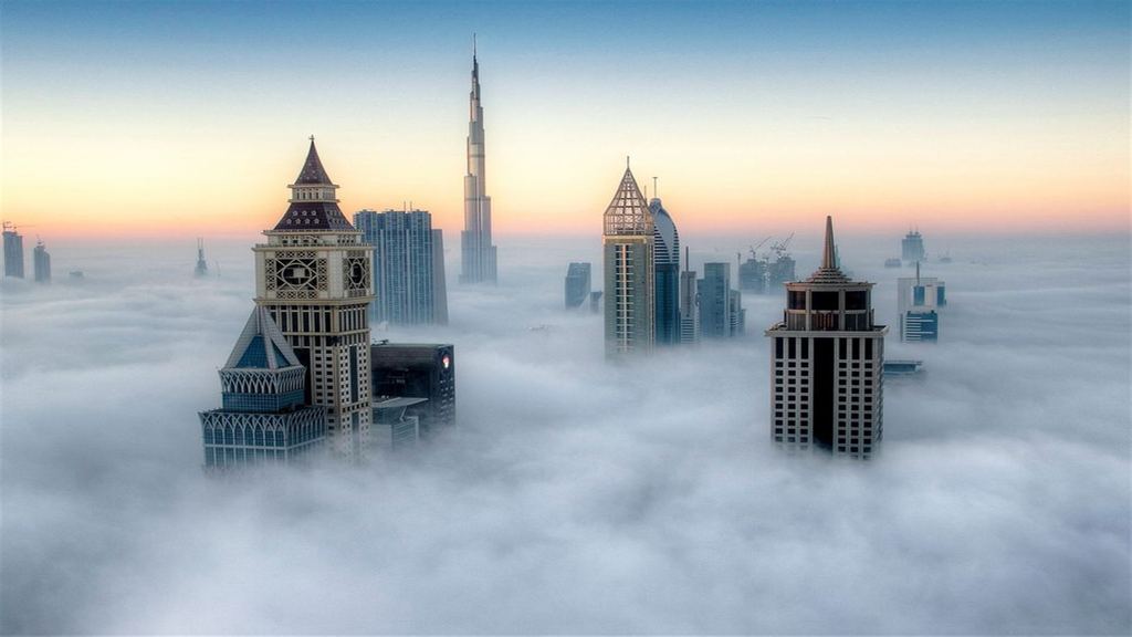 Dubai skyline rising above the clouds
